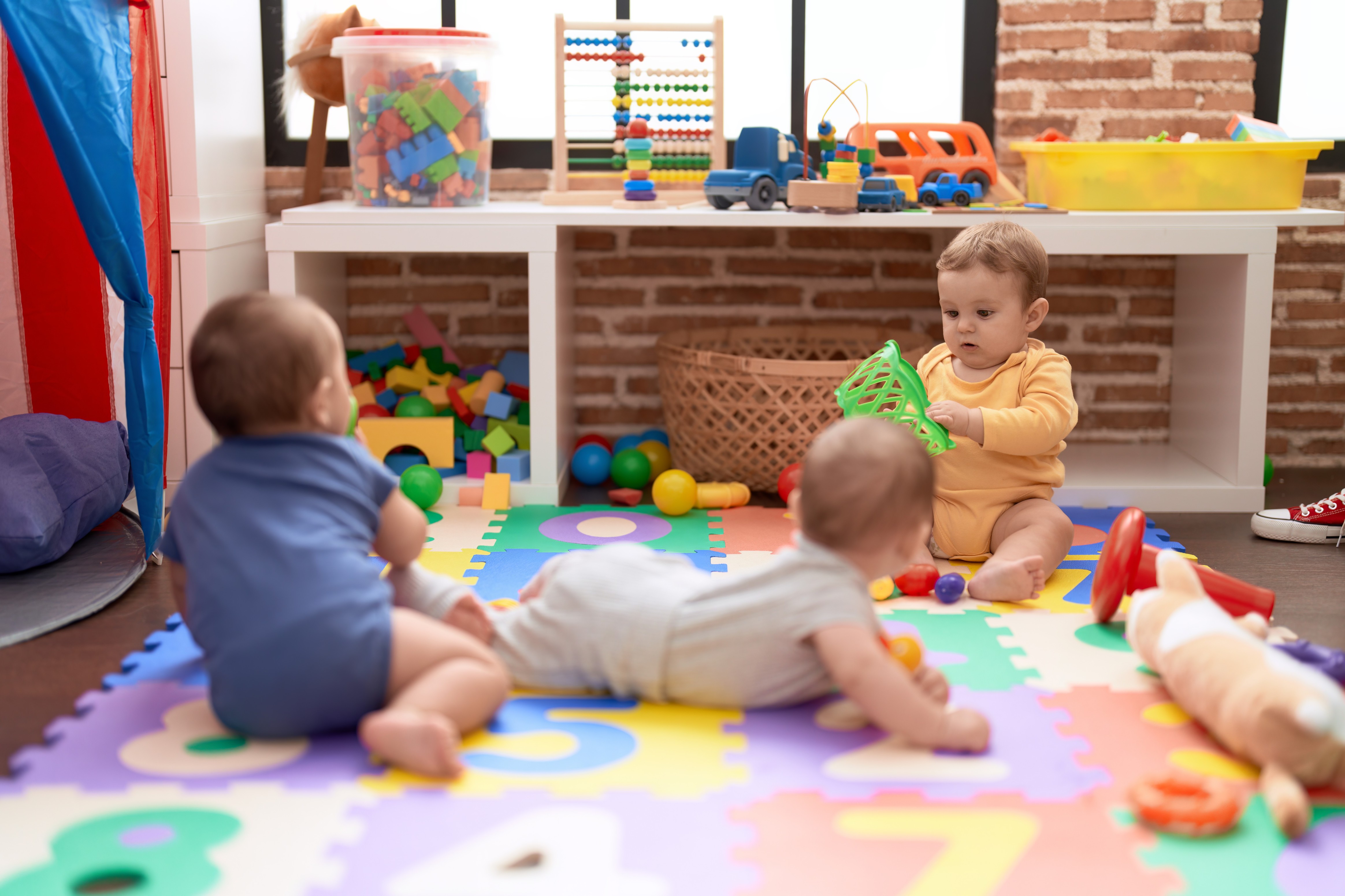 group-toddlers-playing-with-toys-crawling-floor-kindergarten-1-1